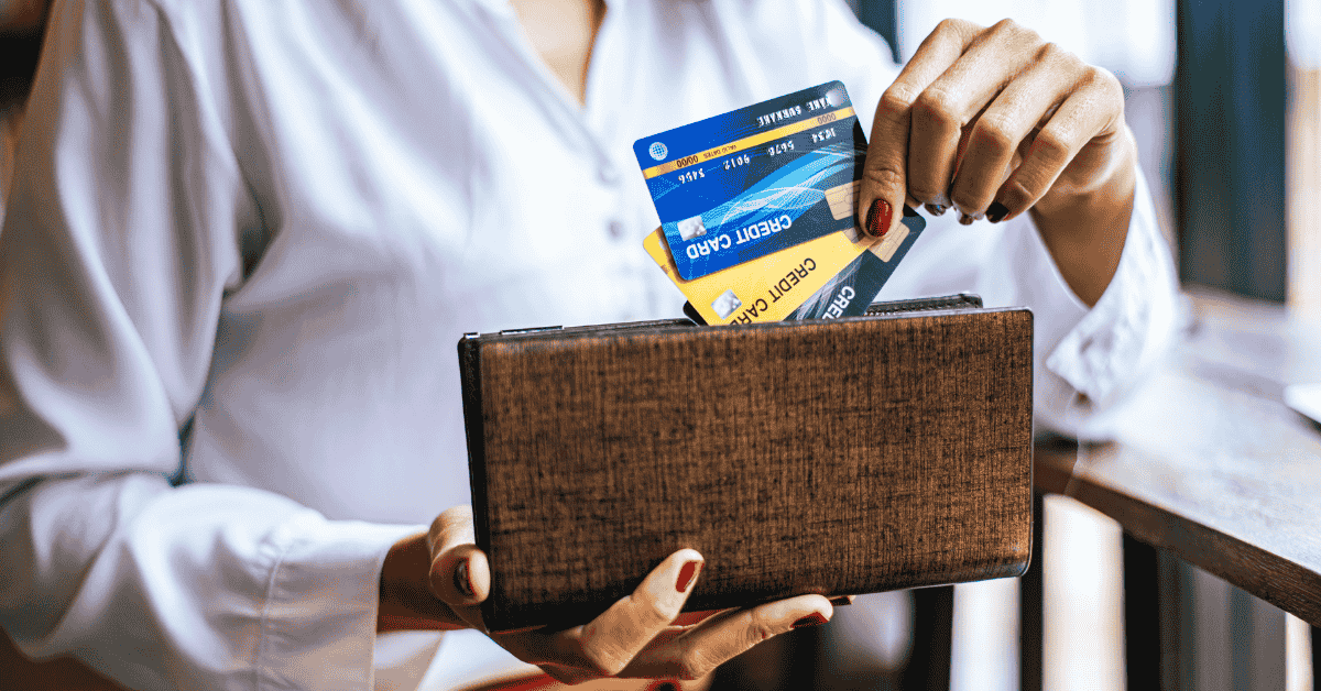 Woman holding a credit card thoughtfully, representing personal finance and credit card use.